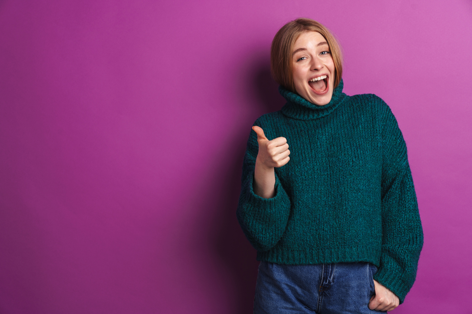 Optimistic Young Woman Showing Thumbs up.